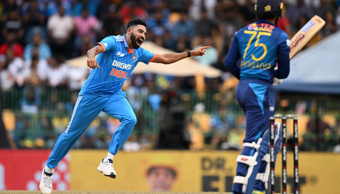 India´s Mohammed Siraj (left) celebrates after taking the wicket of Sri Lanka´s Dhananjaya de Silva during the Asia Cup 2023 final ODI  match between Sri Lanka and India at the R. Premadasa Stadium in Colombo on September 17, 2023. — AFP