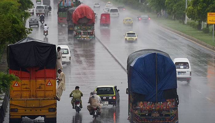 Pakistani motorists drive along a motorway during monsoon rain in Islamabad. – AFP/File