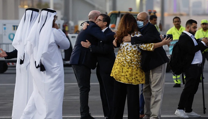 Relatives receive US citizens after they disembark from a Qatari aeroplane. — AFP