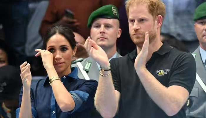 Meghan Markle caught on camera wiping tears alongside Prince Harry