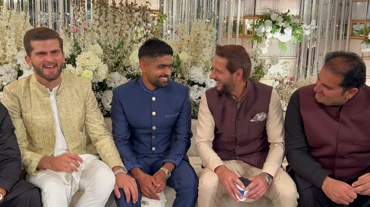 Shaheen Shah Afridi (left), Babar Azam (second left) and Shahid Afridi (second right) laugh while talking. — Author