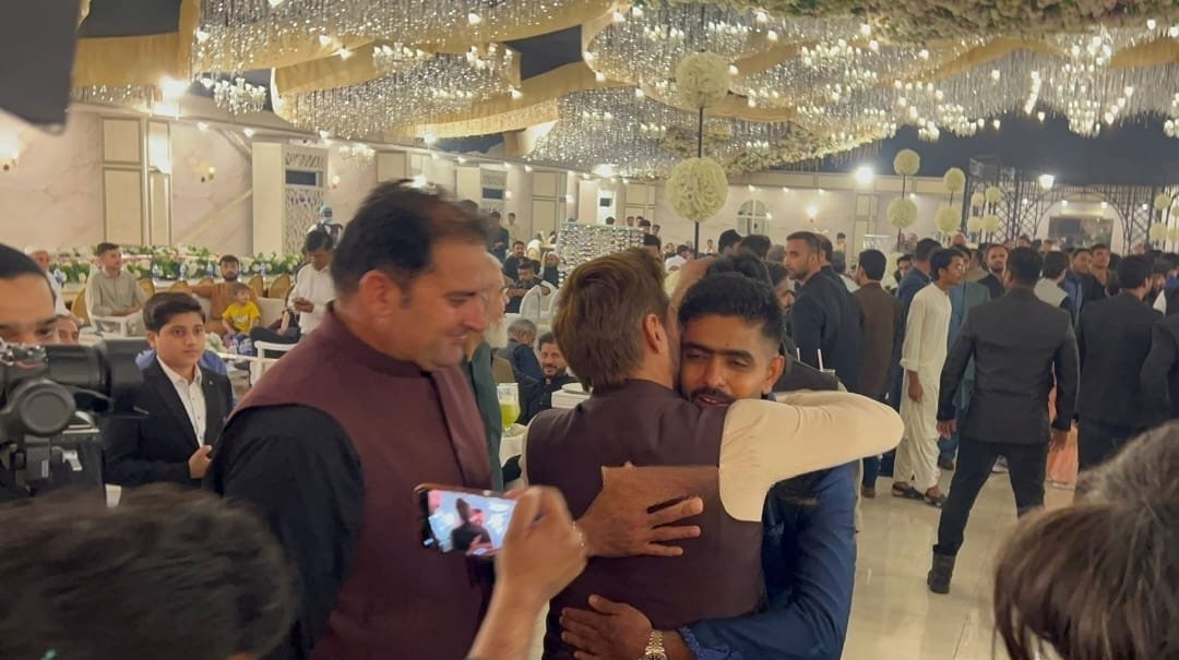 Shahid Afridi hugs Babar Azam as he arrives at the event. — by author