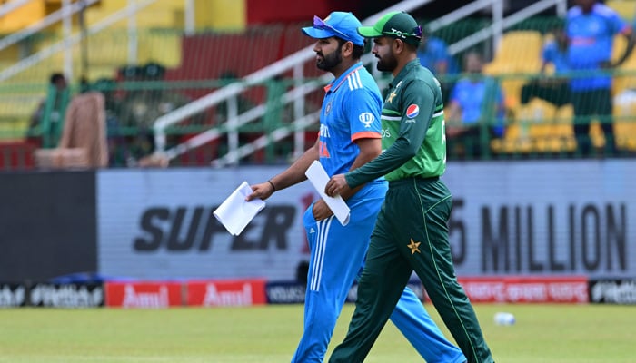 Indias captain Rohit Sharma (left) and Pakistans captain Babar Azam arrive for the toss before the start of the Asia Cup 2023 super four one-day international (ODI) cricket match between India and Pakistan at the R. Premadasa Stadium in Colombo on September 10, 2023. — AFP