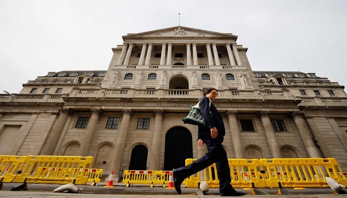 A pedestrian walks past the Bank of England in London. —AFP/File