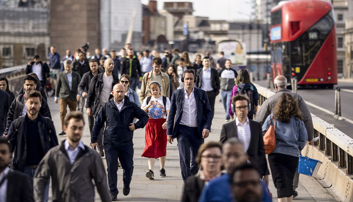Morning commuters on London Bridge going to their workplaces. — X@bloomberg