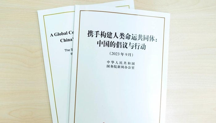 This photo taken on Sept. 26, 2023 shows the Chinese and English versions of a white paper titled A Global Community of Shared Future: Chinas Proposals and Actions. — Chinese Foreign Ministry