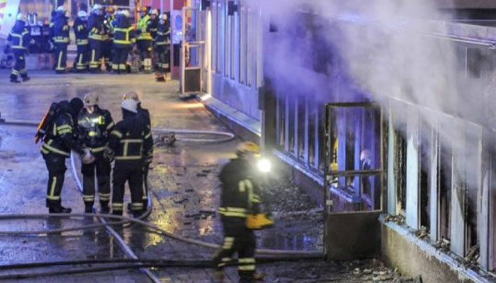 Firefighters outside the Swedish mosque which was set on fire. — AFP