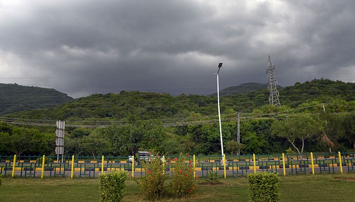 A stunning view of the dark clouds hovering on the Margalla Hills during rainy weather in Federal Capital. — Online/File