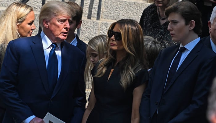 Former President Donald Trump, Melania Trump and Barron Trump exit the funeral of Ivana Trump at St. Vincent Ferrer Roman Catholic Church on July 20, 2022 in New York City. — AFP