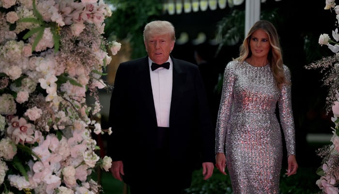 Former US President Donald Trump and former first lady Melania Trump arrive for a New Years event at his Mar-a-Lago home on December 31, 2022, in Palm Beach, Florida. — AFP