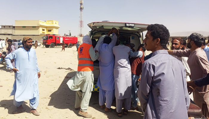 People standing around an ambulance after a blast through Mastung, on September 29, 2023. — Reporter