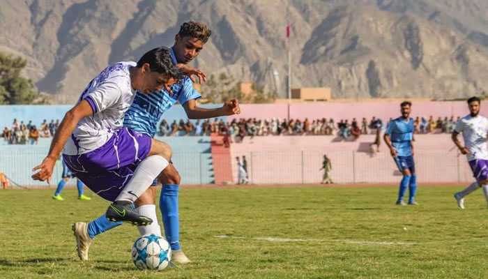 Players jostle for the ball during a football match — Directorate General of Sports Balochistan