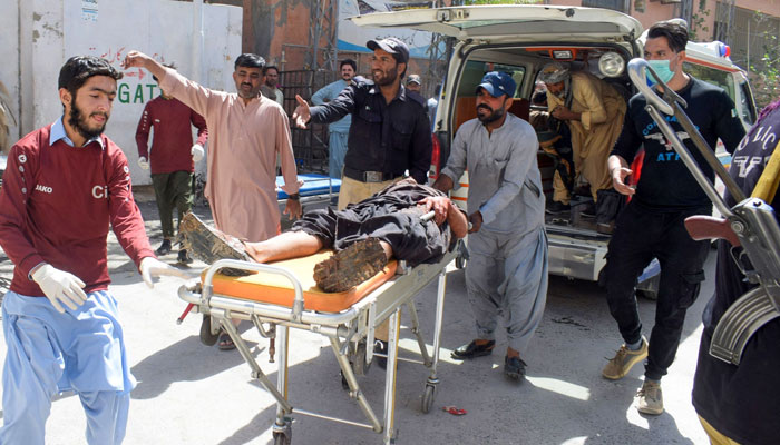 Volunteers carry a blast victim on a stretcher at a hospital in Quetta on September 29, 2023, after a suicide bombing in Mastung district. — AFP