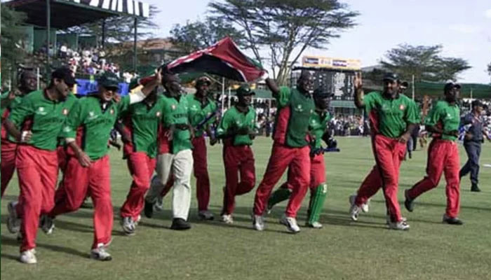 Kenya players run across the field holding the national flag after thumping Sri Lanka and shocking the cricket world. — Reuters/File