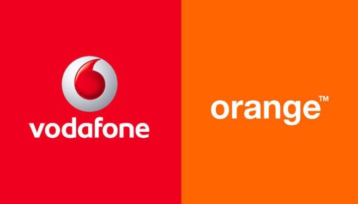 Logos of European telecommunication giants Vodafone and Orange. — AFP