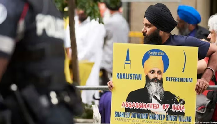 This picture shows a Canadian Sikh holding a poster of Khalistan activist Hardeep Singh Nijjar dueing a demonstration. — AFP/File