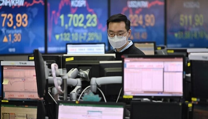 A currency dealer wearing a face mask monitors exchange rates in a trading room at KEB Hana Bank in Seoul. — AFP/File