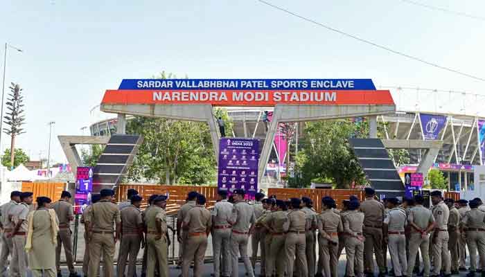Police personnel gather outside the Narendra Modi Stadium in Ahmedabad on October 4, 2023. — AFP