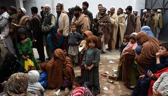 Afghan refugees gather for renewal of their family cards at the Chamkany registration center on the outskirts of Peshawar. — AFP/File