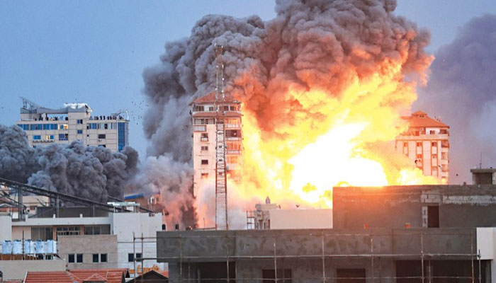 A fireball and smoke rise above a building in Gaza City on Saturday during an Israeli air strike. — AFP/File