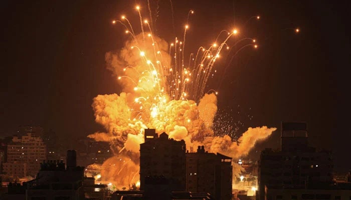 A missile explodes in Gaza City during an Israeli air strike on October 8, 2023. — AFP