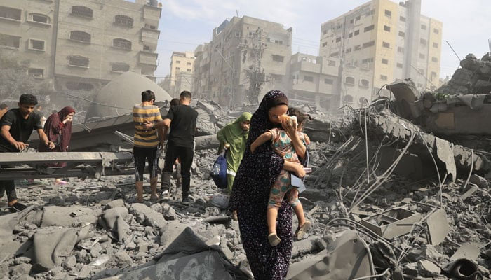 Palestinians in Gaza City inspect the damage following an Israeli airstrike, on 9 October 2023. — AFP