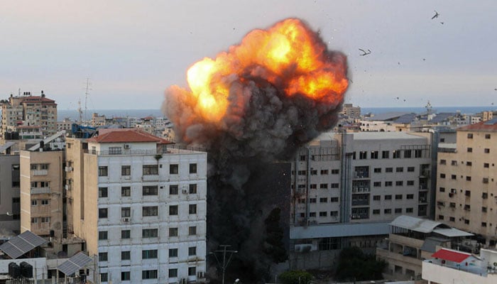 Fire and smoke rise after an Israeli air strike targeted the National Bank on Gaza City, on October 8, 2023. — AFP
