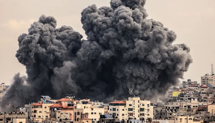 A plume of smoke rises over Gaza City during an Israeli airstrike on Oct. 9. — AFP