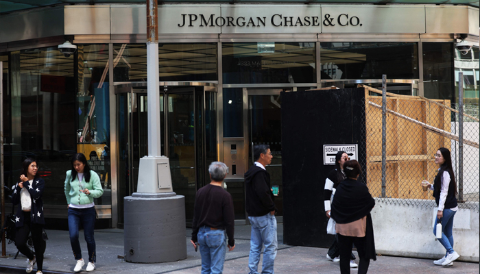 People pass the JPMorgan Chase headquarters building on May 26, 2023, in New York City. — AFP