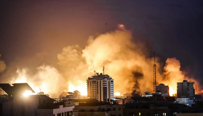 A fireball erupts during Israeli bombardment of Gaza City on October 9, 2023. — AFP