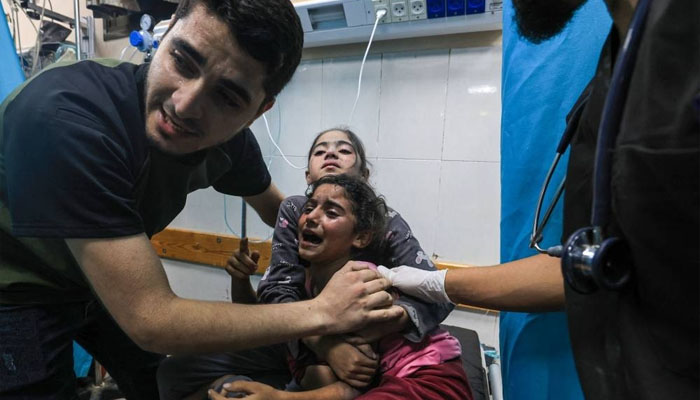Children injured in an Israeli airstrike react as they receive treatment in a Gaza hospital on Tuesday. — AFP