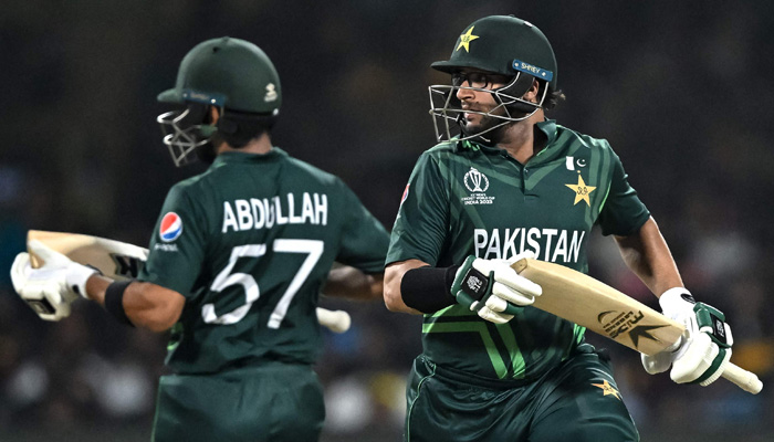 Pakistans Abdullah Shafique (L) and Imam-ul-Haq run between the wickets during the 2023 ICC Men´s Cricket World Cup one-day international (ODI) match between Australia and Pakistan at the M. Chinnaswamy Stadium in Bengaluru on October 20, 2023. — AFP