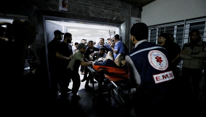 An injured person is assisted at Shifa Hospital after hundreds of Palestinians were killed in a blast at Al-Ahli hospital in Gaza City, Gaza Strip, October 17, 2023. — AFP