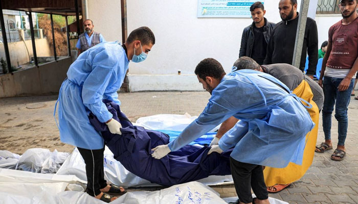 Medics place the body of a Palestinian martyred in an Israeli air strike at a hospital in Rafah in the southern Gaza Strip, on Thursday, Oct. 19, 2023. — AFP