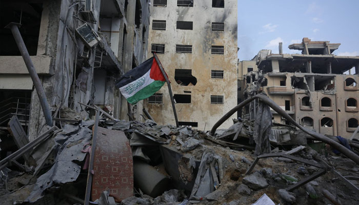 A Palestinian flag is seen on the rubble of a building destroyed in Israeli airstrikes in Gaza Citys Rimal district, Palestine, Oct. 10, 2023. — AFP