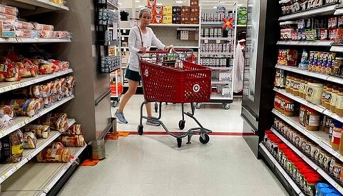 An American shopping for groceries in a US supermarket. — AFP/File