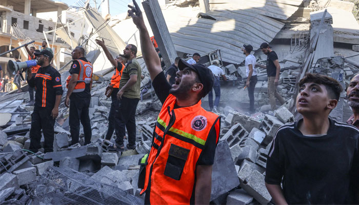 Rescuers communicate with each other as they sift through the rubble of a collapsed building following an Israeli air strike on Rafah in the southern Gaza Strip on October 26, 2023, amid ongoing battles between Israel and Palestine. — AFP
