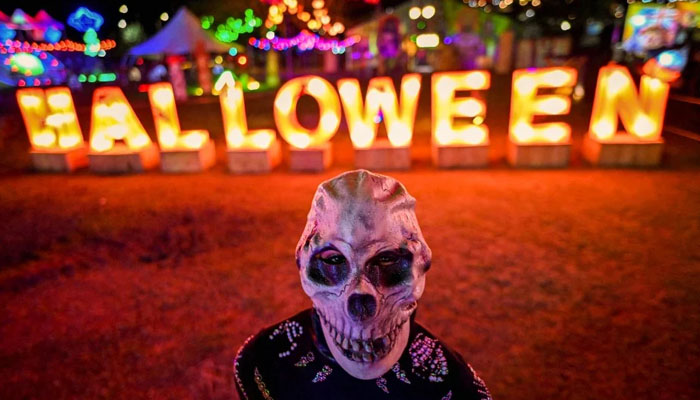 A person wears a skeleton mask during a show in River View Park in Cali, Columbia. — AFP/File