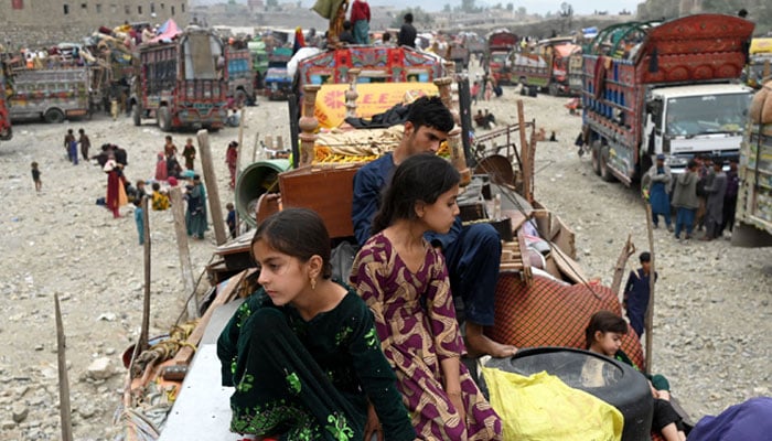 Afghan refugees arrive with their belongings on trucks from Pakistan at the Afghanistan-Pakistan Torkham border in Nangarhar province on November 1, 2023. — AFP