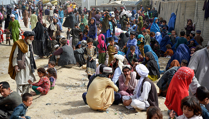 In this photo taken on November 1, 2023, Afghan refugees wait near a registration centre upon their arrival from Pakistan, at the Afghanistan-Pakistan border in the Spin Boldak district of Kandahar province. — AFP