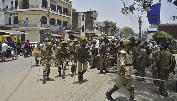 India forces carrying batons can be seen in the northern Uttar Pradesh state in this undated image. — AFP