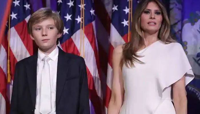Melania Trump and Barron Trump gesture during a political gathering. — AFP/File
