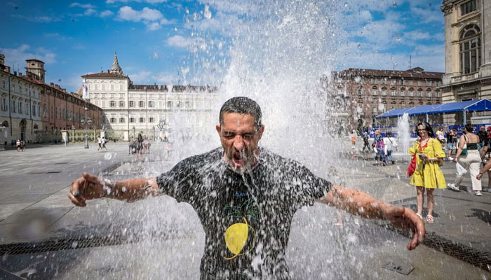 A man cools off in a fountain in Turin, Italy, during the Cerberus heatwave on Saturday. — X/@epa