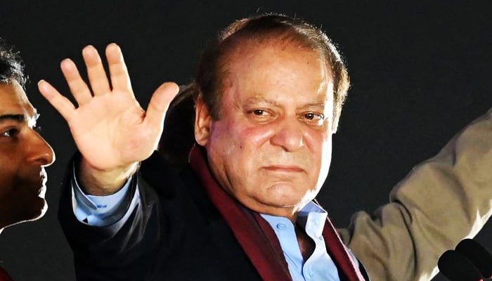 Nawaz Sharif waves at supporters during his homecoming rally in Lahore, on October 21, 2023. — AFP