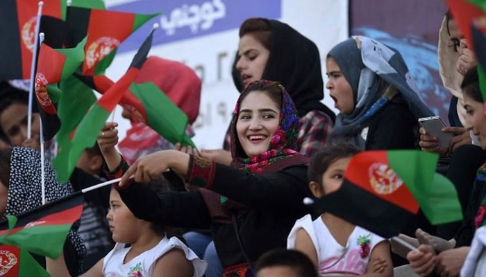 Afghan women wave flags at the Afghanistan Football Federation (AFF) stadium in Kabul. — AFP/File