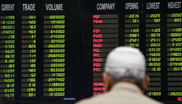 Pakistani traders stand beneath an electronic board displaying share prices at the Pakistani Stock Exchange (PSX). — INP/File