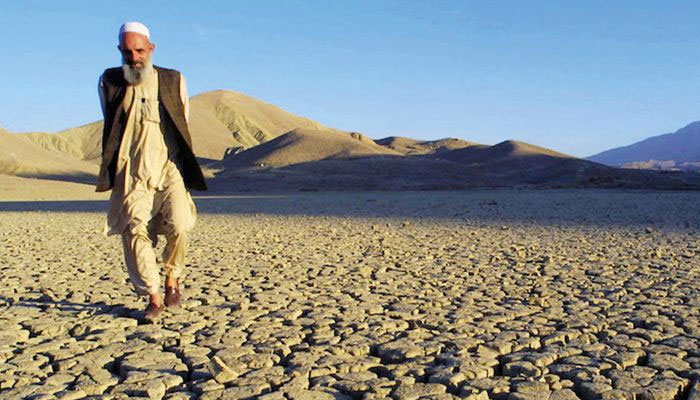 A man walks on the dried, cracked landscape near Hanna Lake near Quetta, Pakistan. — AFP/File