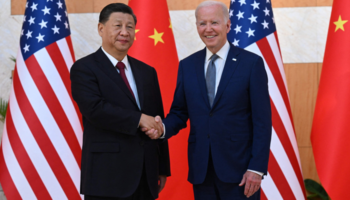 US President Joe Biden (R) and Chinas President Xi Jinping (L) shake hands as they meet on the sidelines of the G20 Summit in Nusa Dua on the Indonesian resort island of Bali on November 14, 2022. — AFP