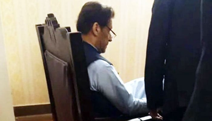PTI Chairman Imran Khan sits in a chair in the NAB court in Islamabad on May 10, 2023. — PPI