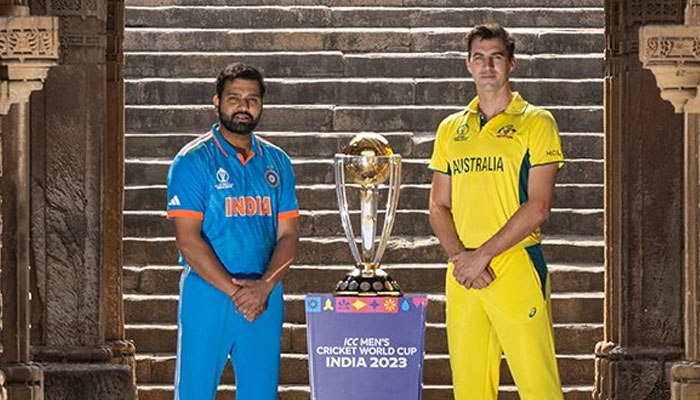 Indian skipper Rohit Sharma (left) and Australian captain Pat Cummins pose with the ICC Mens Cricket World Cup 2023 trophy. — X/@ICC